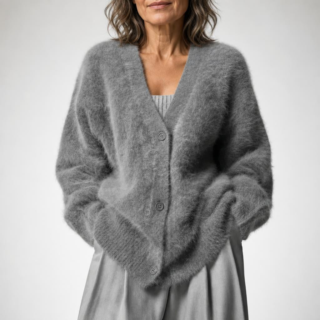 Oversized women's cardigan featuring a deep V-neck and relaxed fit, made from soft knit fabric, perfect for layering. 8