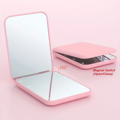 Pocket makeup mirror with LED light and dual magnification, featuring a compact design in stylish pink and green colors, perfect for on-the-go touch-ups and 2