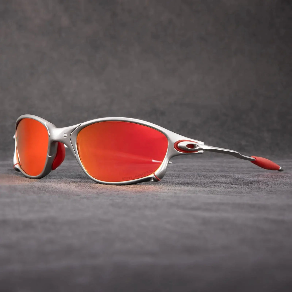 Polarized sports sunglasses featuring red mirrored lenses and UV400 protection, designed with a lightweight metal frame, ideal for cycling and outdoor activities. 1