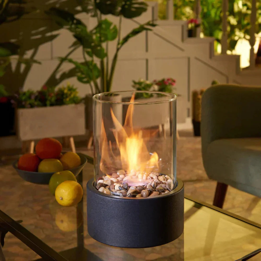 Portable tabletop fireplace featuring a sleek design with a bioethanol burner and glass panels, perfect for modern indoor settings. 2