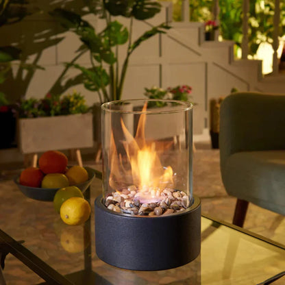 Portable tabletop fireplace featuring a sleek design with a bioethanol burner and glass panels, perfect for modern indoor settings. 2