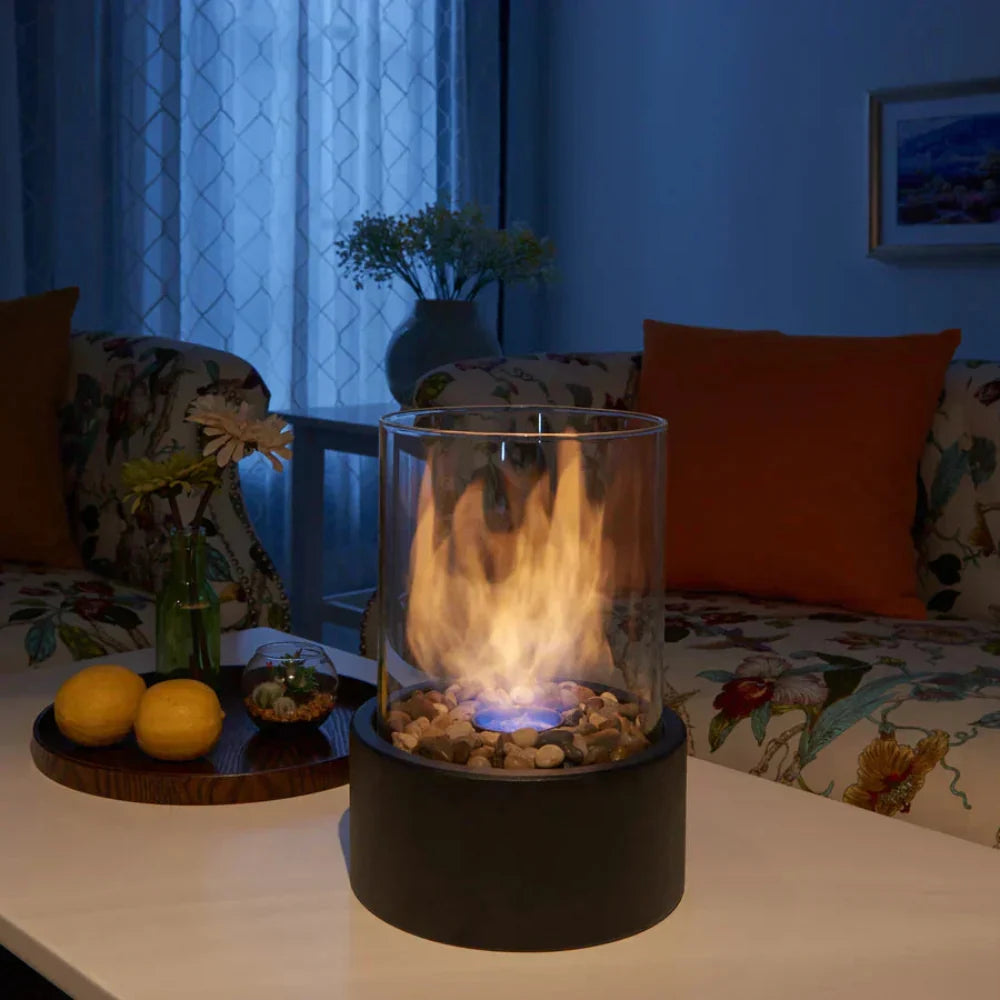 Portable tabletop fireplace featuring a sleek design with a bioethanol burner and glass panels, perfect for modern indoor settings. 3