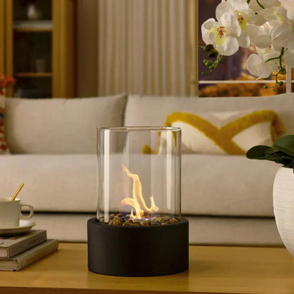 Portable tabletop fireplace featuring a sleek design with a bioethanol burner and glass panels, perfect for modern indoor settings. 4