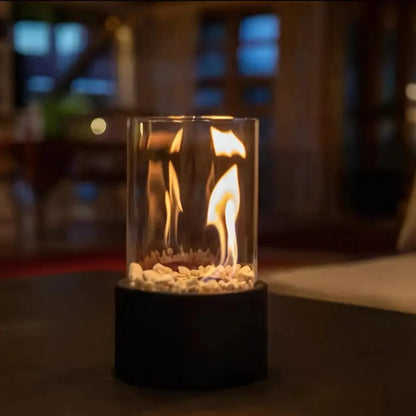 Portable tabletop fireplace featuring a sleek design with a bioethanol burner and glass panels, perfect for modern indoor settings. 5