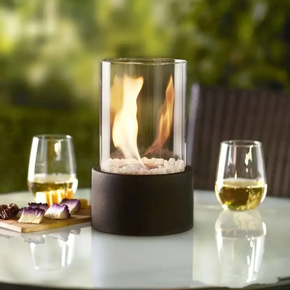 Portable tabletop fireplace featuring a sleek design with a bioethanol burner and glass panels, perfect for modern indoor settings. 7