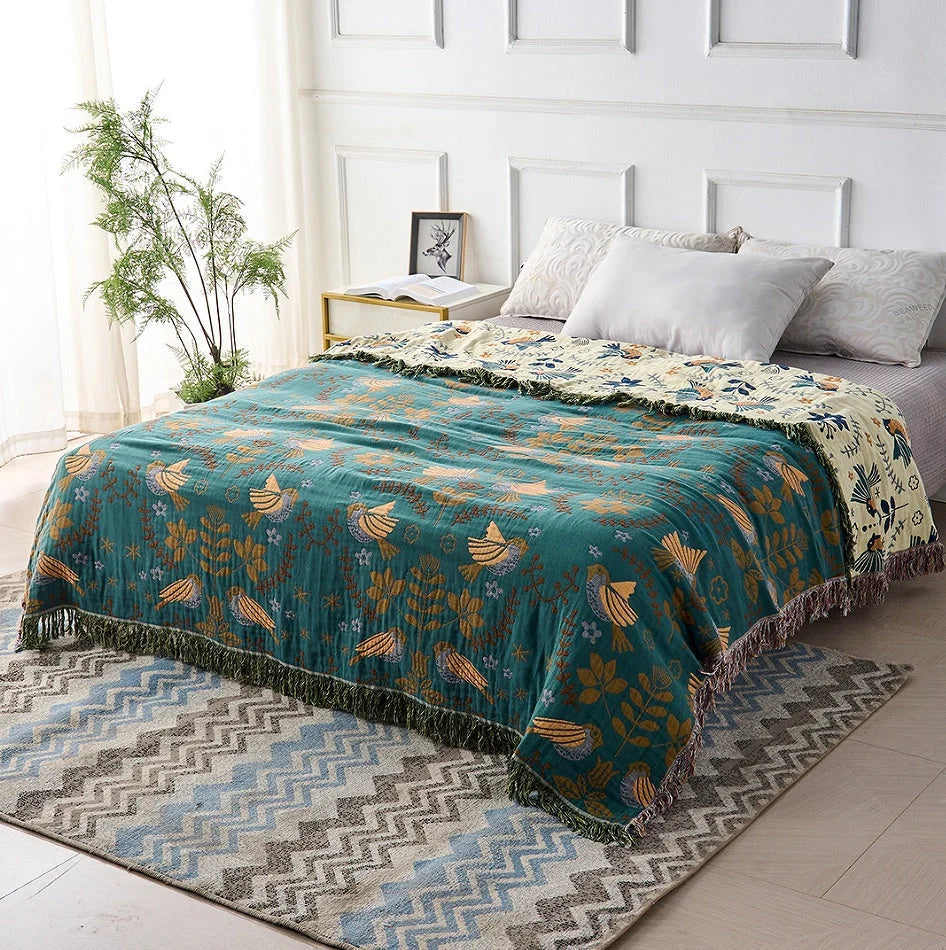Reversible Scandinavian bird print throw blanket in multicolor, perfect for outdoor use, showcasing a vibrant design with birds and nature motifs. 1