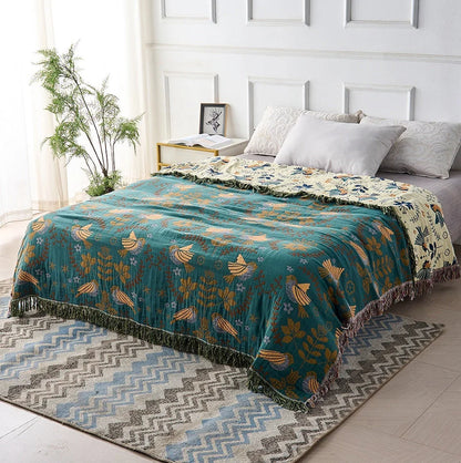Reversible Scandinavian bird print throw blanket in multicolor, perfect for outdoor use, showcasing a vibrant design with birds and nature motifs. 1