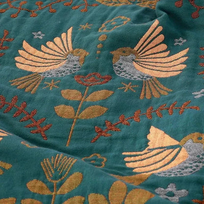 Reversible Scandinavian bird print throw blanket in multicolor, perfect for outdoor use, showcasing a vibrant design with birds and nature motifs. 2