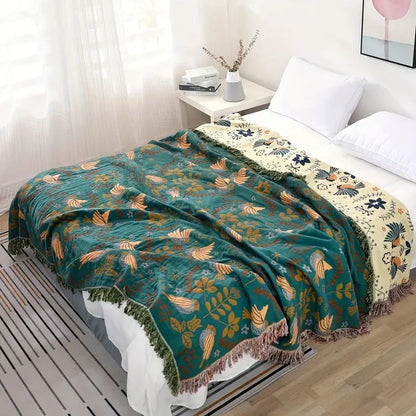 Reversible Scandinavian bird print throw blanket in multicolor, perfect for outdoor use, showcasing a vibrant design with birds and nature motifs. 3