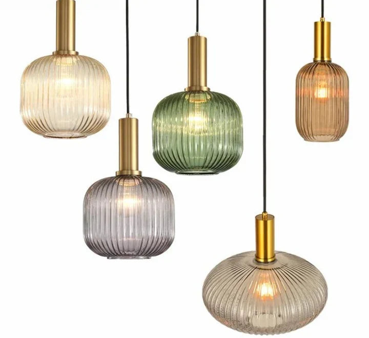 Ribbed glass pendant lights featuring a modern metal tube fitting, providing a warm ambient glow ideal for kitchen and dining spaces. 1