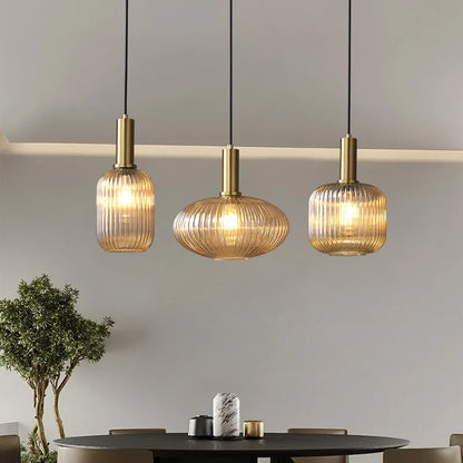 Ribbed glass pendant lights featuring a modern metal tube fitting, providing a warm ambient glow ideal for kitchen and dining spaces. 5