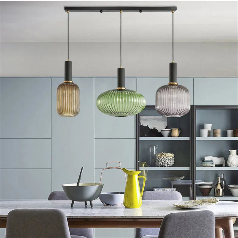 Ribbed glass pendant lights featuring a modern metal tube fitting, providing a warm ambient glow ideal for kitchen and dining spaces. 6