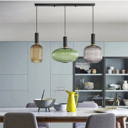 Ribbed glass pendant lights featuring a modern metal tube fitting, providing a warm ambient glow ideal for kitchen and dining spaces. 6