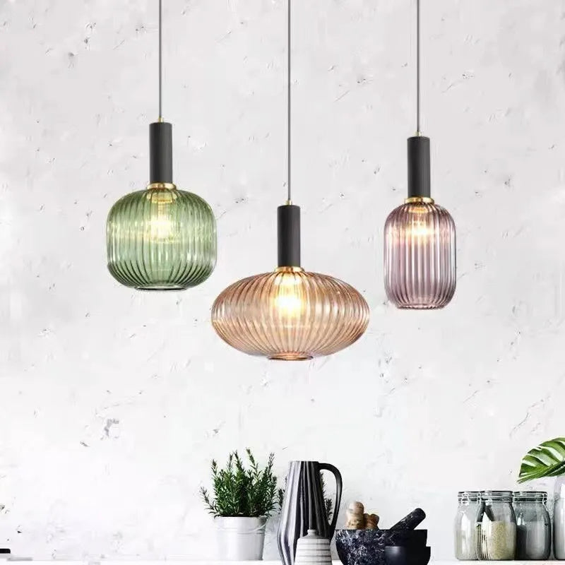 Ribbed glass pendant lights featuring a modern metal tube fitting, providing a warm ambient glow ideal for kitchen and dining spaces. 7