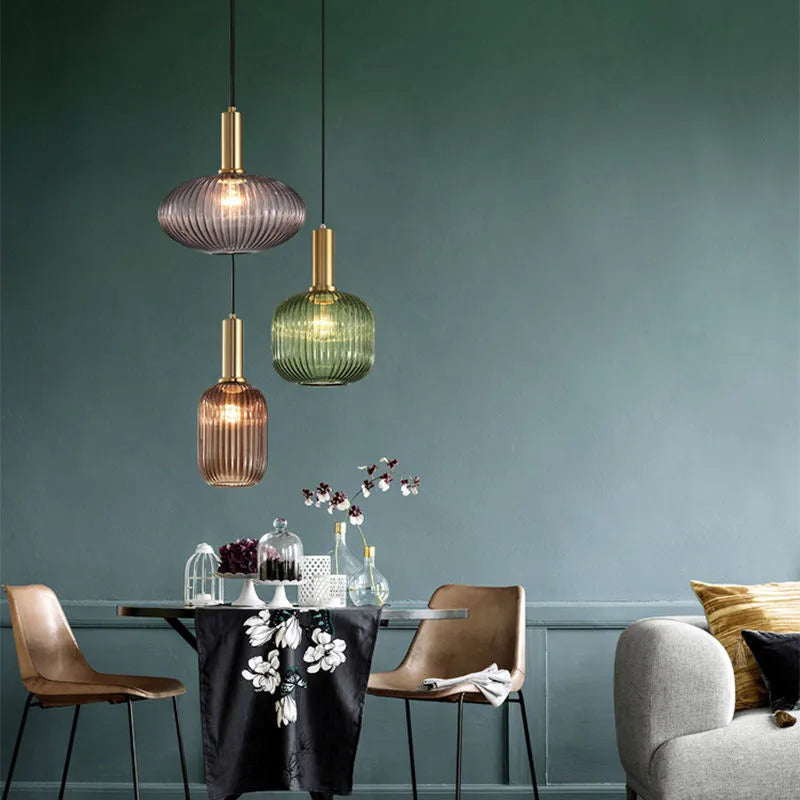Ribbed glass pendant lights featuring a modern metal tube fitting, providing a warm ambient glow ideal for kitchen and dining spaces. 8