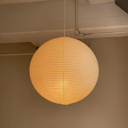Rice Paper Pendant Lights with a ribbed shade designed for minimalist kitchen island lighting, showcasing a hardwired design available in multiple sizes. 2