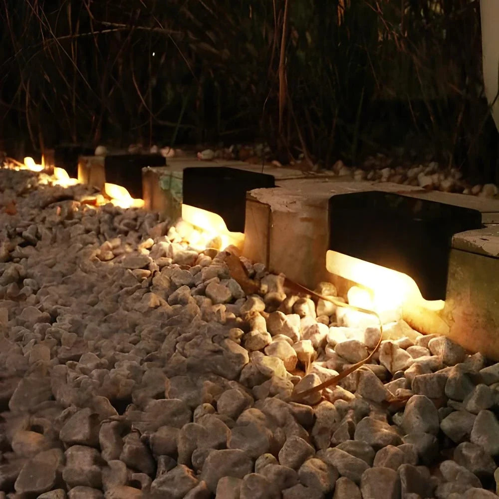 Solar step lights for outdoor use, featuring a compact design in brown or black housing, sold in an 8 pack, ideal for illuminating pathways and enhancing 4