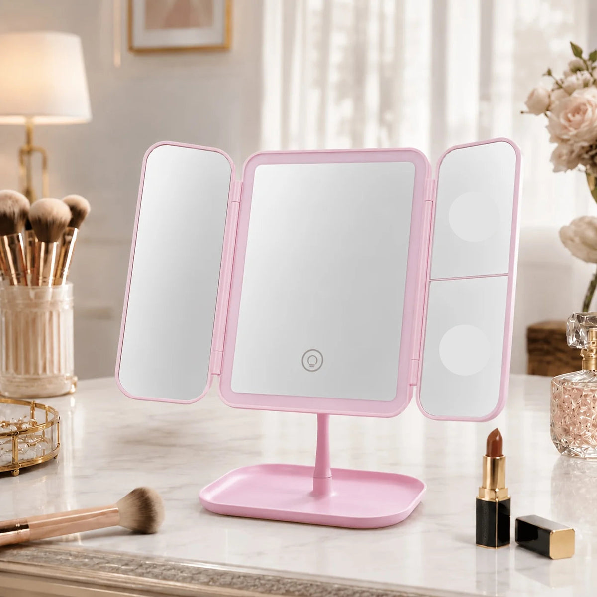 Tri-fold makeup mirror in white and pink featuring a touch light and 1X, 2X, 3X magnification for enhanced makeup application 1