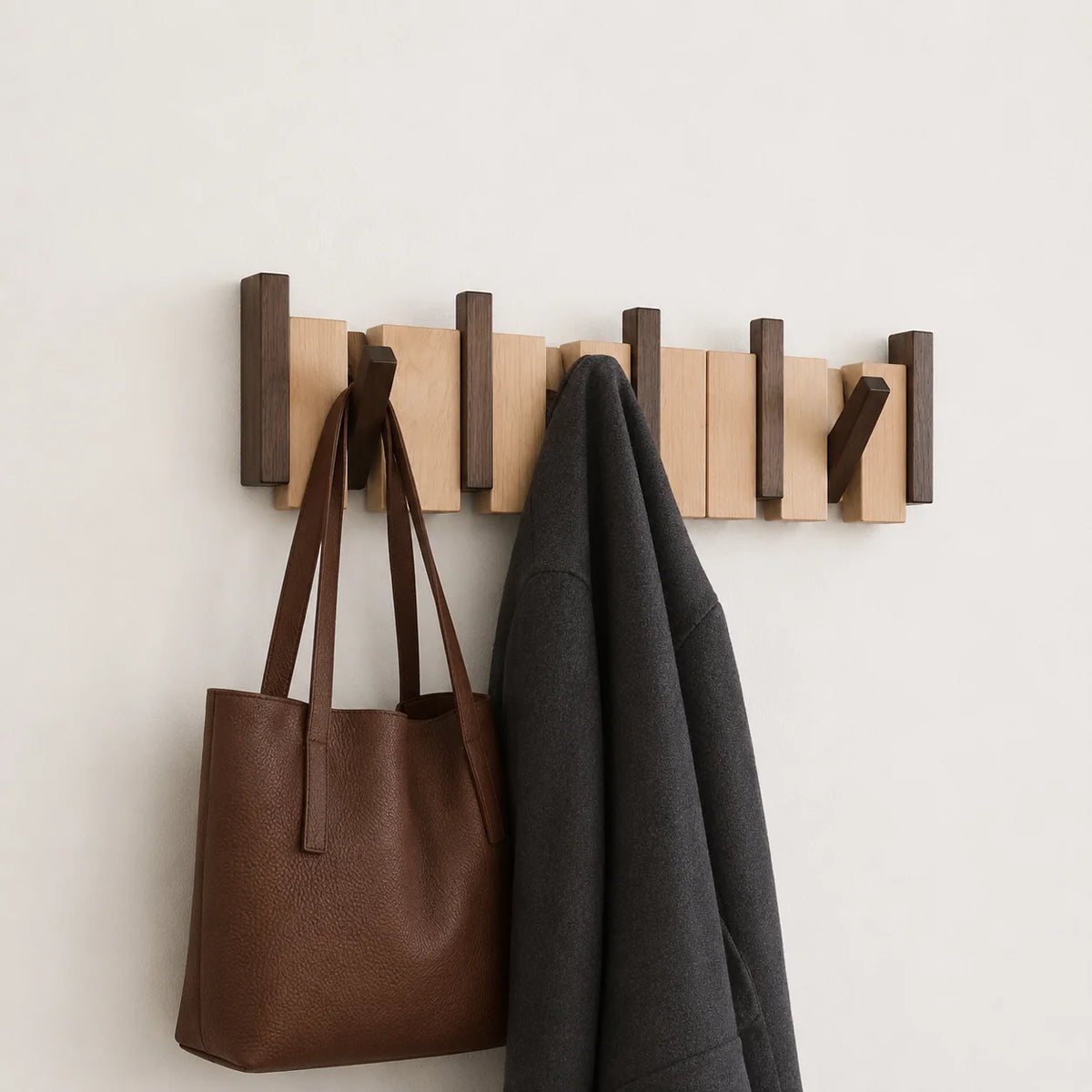 Wall mounted coat rack with foldable hooks in a modern wooden design featuring a natural finish, ideal for organizing coats and accessories in entryways or hallways 2