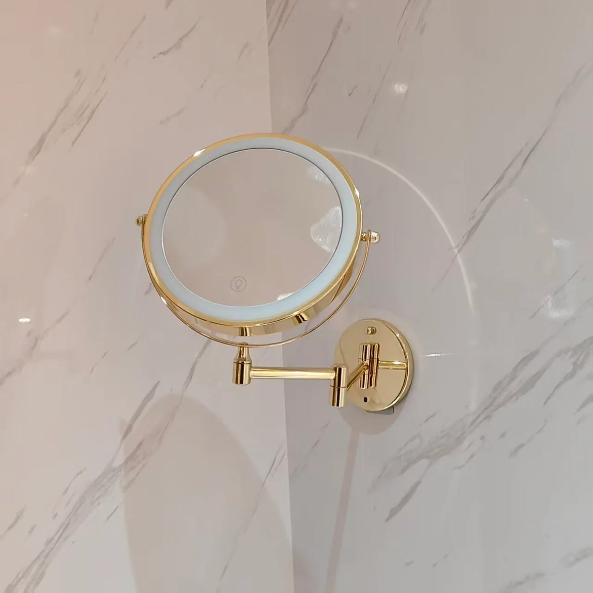 Wall mounted makeup mirror with LED light and magnification in a gold stainless steel finish, perfect for enhancing your beauty routine. 3