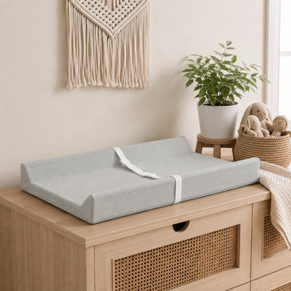 Waterproof baby changing pad with cushioned contoured support, featuring a neutral design ideal for modern nurseries. 0