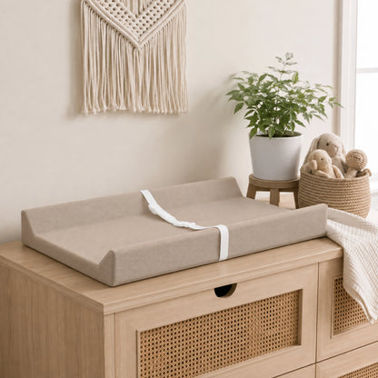 Waterproof baby changing pad with cushioned contoured support, featuring a neutral design ideal for modern nurseries. 1