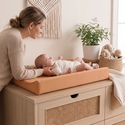 Waterproof baby changing pad with cushioned contoured support, featuring a neutral design ideal for modern nurseries. 4