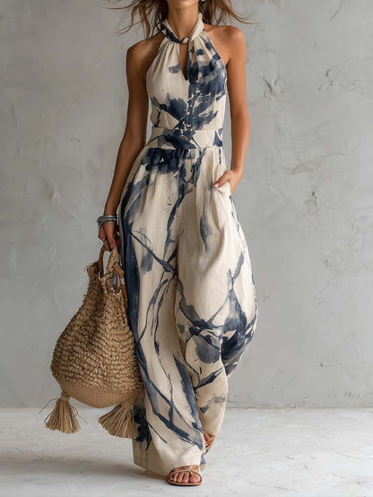 Wide-leg jumpsuit for women featuring a stylish halter neckline and convenient side pockets, designed in a bohemian ink wash print. 0
