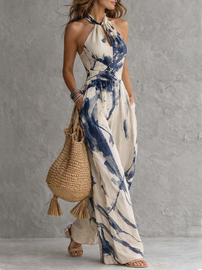 Wide-leg jumpsuit for women featuring a stylish halter neckline and convenient side pockets, designed in a bohemian ink wash print. 1
