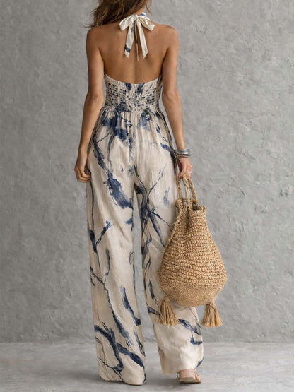 Wide-leg jumpsuit for women featuring a stylish halter neckline and convenient side pockets, designed in a bohemian ink wash print. 2
