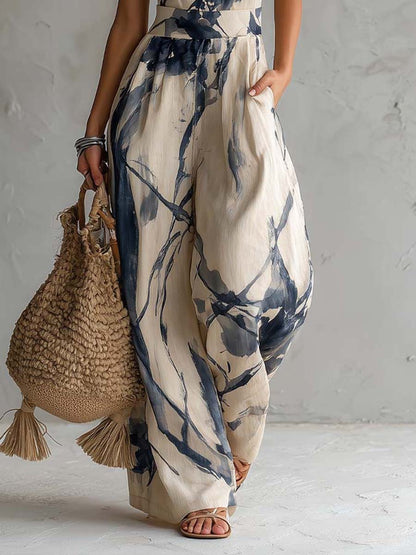 Wide-leg jumpsuit for women featuring a stylish halter neckline and convenient side pockets, designed in a bohemian ink wash print. 4