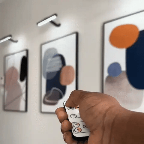 Wireless LED picture light featuring a sleek modern design, dimmable brightness, and a 360° rotating head, perfect for illuminating artwork and photographs; 4