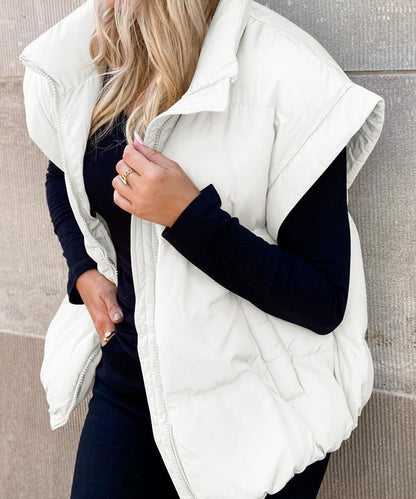 Women's black puffer vest featuring a high stand collar and zip front, designed for lightweight warmth and stylish layering. 5