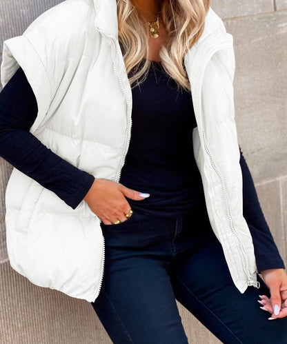 Women's black puffer vest featuring a high stand collar and zip front, designed for lightweight warmth and stylish layering. 6
