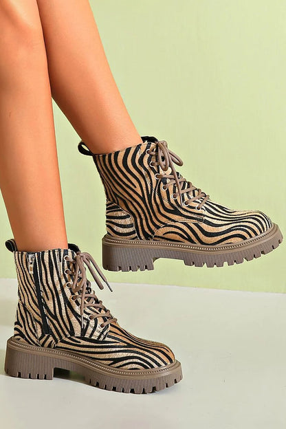 Women's zebra print khaki lace-up boots featuring a sleek silhouette, perfect for stylish and trendy fall and winter outfits. 1