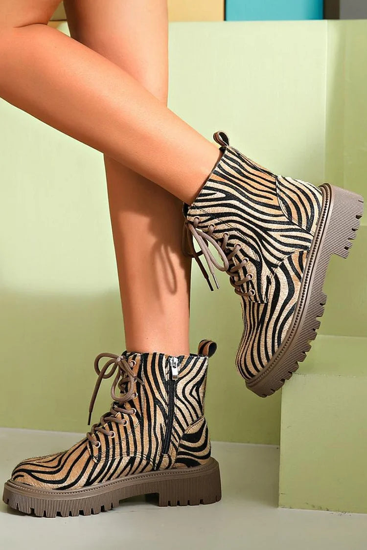 Women's zebra print khaki lace-up boots featuring a sleek silhouette, perfect for stylish and trendy fall and winter outfits. 2