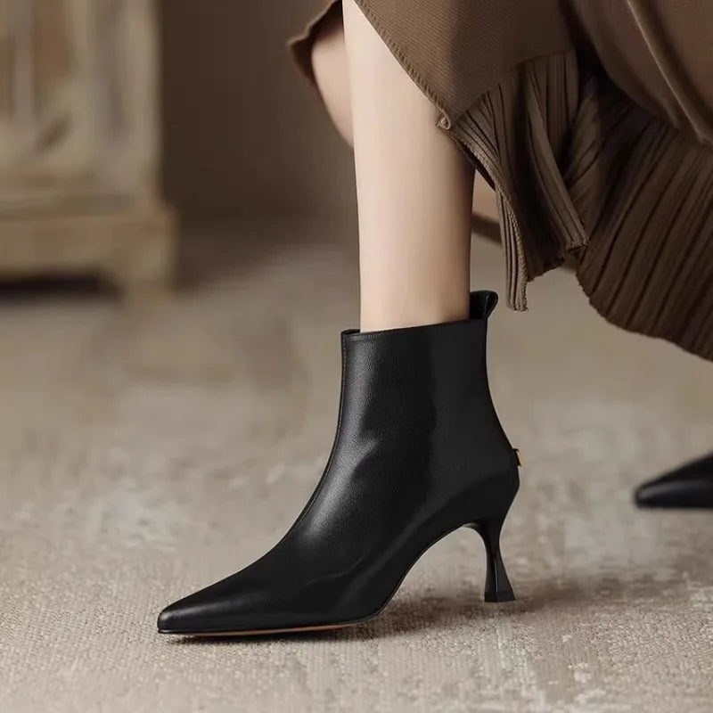 Elegant black women's boots featuring a slender kitten heel and pointed toe, designed for all-day comfort and style. 0