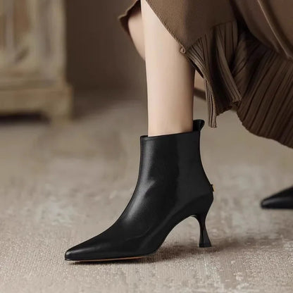 Elegant black women's boots featuring a slender kitten heel and pointed toe, designed for all-day comfort and style. 0