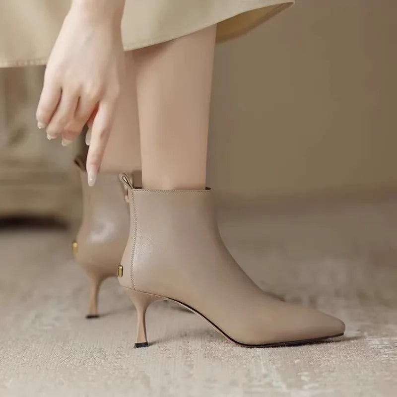 Elegant black women's boots featuring a slender kitten heel and pointed toe, designed for all-day comfort and style. 5