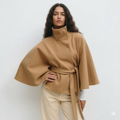 Women's cape coat featuring an adjustable waist belt and high neck, designed for elegant winter layering in a soft polyester blend fabric. 1
