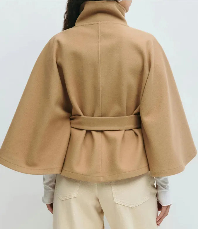 Women's cape coat featuring an adjustable waist belt and high neck, designed for elegant winter layering in a soft polyester blend fabric. 3