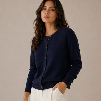 Women's cashmere cardigan featuring a button front and round neck, designed in a fitted style for versatile layering, perfect for both casual and formal occasions. 1