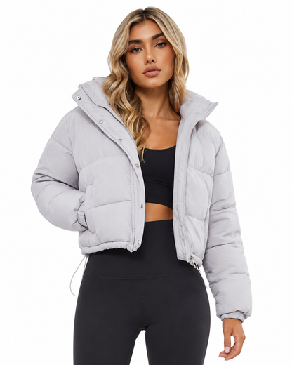 Women's cropped hooded puffer jacket featuring a zip closure and quilted insulated design, perfect for winter warmth and style. 1