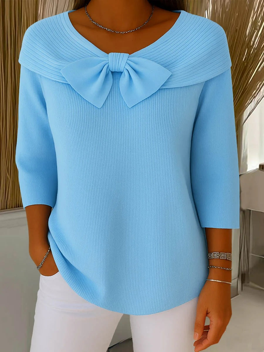 Women's fitted sweater with bow detail in soft fabric, featuring a cozy minimalist design perfect for an elegant autumn style. 0