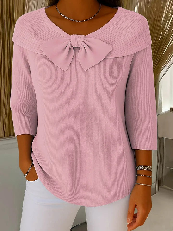 Women's fitted sweater with bow detail in soft fabric, featuring a cozy minimalist design perfect for an elegant autumn style. 1
