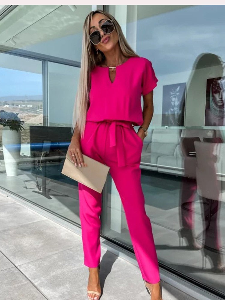 Women's elegant black jumpsuit featuring a flattering V-neckline and comfortable elastic waistband, perfect for transitioning from day to night. 0