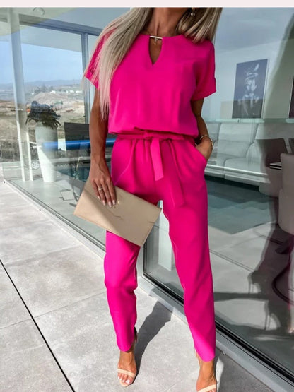 Women's elegant black jumpsuit featuring a flattering V-neckline and comfortable elastic waistband, perfect for transitioning from day to night. 1