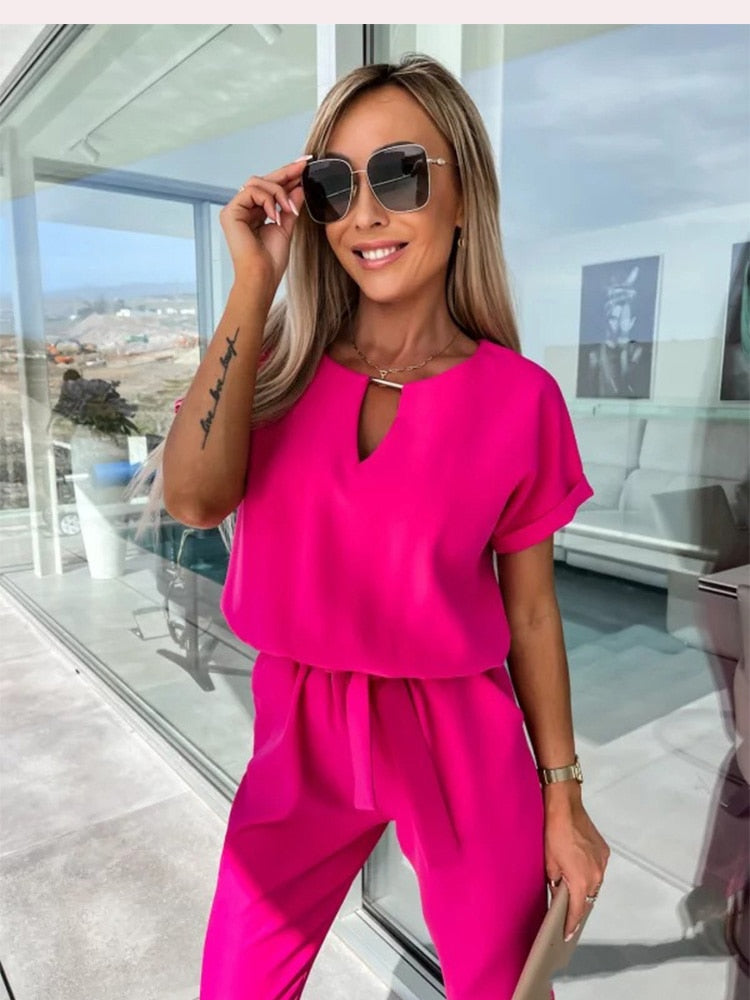 Women's elegant black jumpsuit featuring a flattering V-neckline and comfortable elastic waistband, perfect for transitioning from day to night. 2