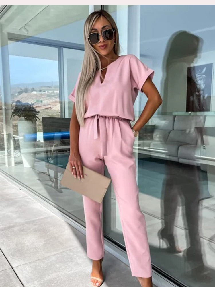 Women's elegant black jumpsuit featuring a flattering V-neckline and comfortable elastic waistband, perfect for transitioning from day to night. 3