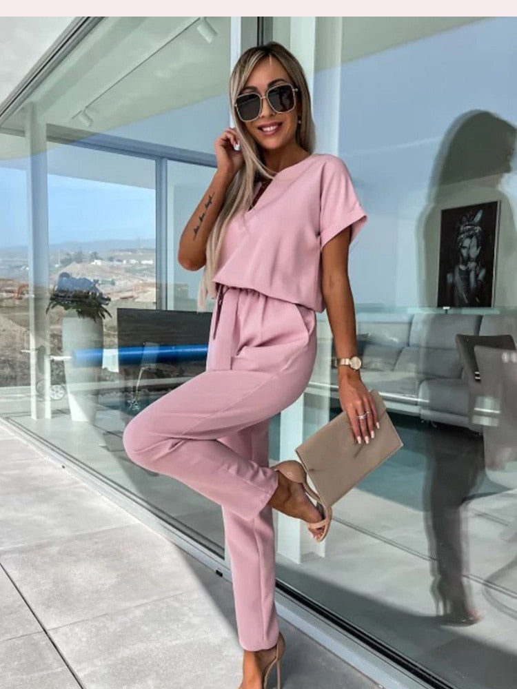 Women's elegant black jumpsuit featuring a flattering V-neckline and comfortable elastic waistband, perfect for transitioning from day to night. 4